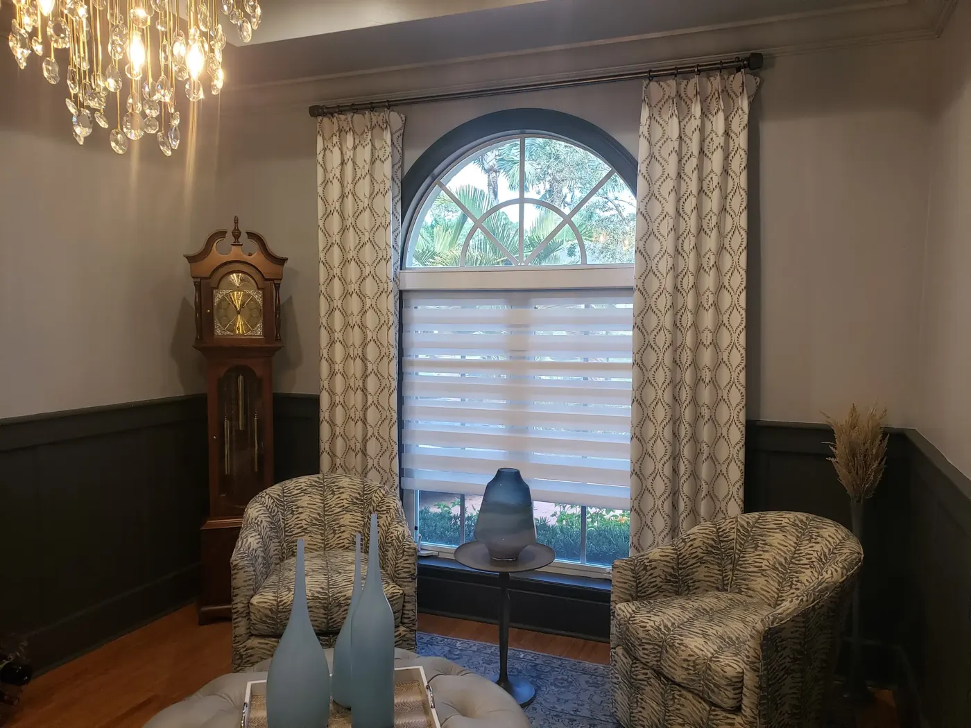 Living room with motorized shade on an arched window